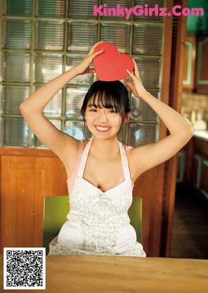A woman in a blue and white bathing suit posing for a picture.