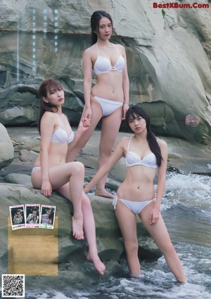 A group of three women in bikinis standing next to each other.