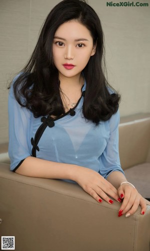 A woman in a school uniform posing for a picture.