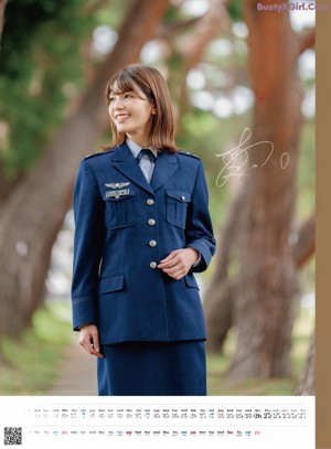 A woman in a military uniform waving at the camera.
