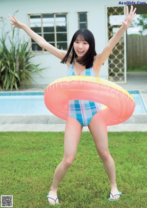 a woman in a blue polka dot swimsuit posing for the camera