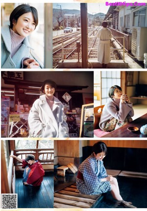 A woman standing on a train track next to a train station.