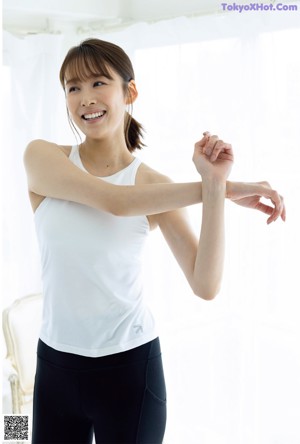 A woman with long brown hair is posing for a magazine cover.