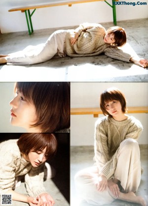 A woman in a beige sweater is laying on the floor.