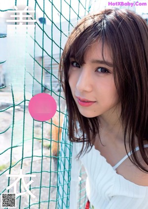 A woman in a black lingerie posing for the camera.