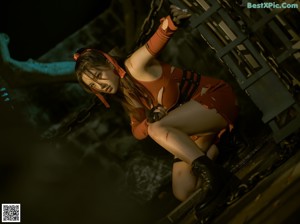 A woman in a black leather outfit is chained to a pole.