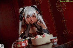 A woman sitting on a couch holding a bowl of food.