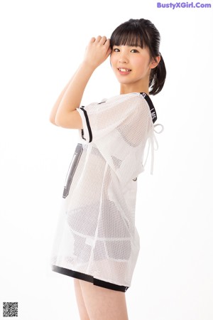 A woman in a white shirt and shorts posing for a picture.