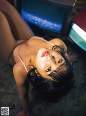 A woman in a bikini sitting on a chair in a room.