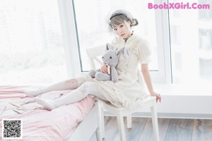 A woman holding a stuffed animal in front of her face.